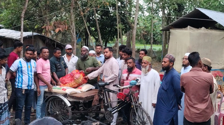 Humanity’s Messenger Palash Rahman Stands Beside Fire Victim